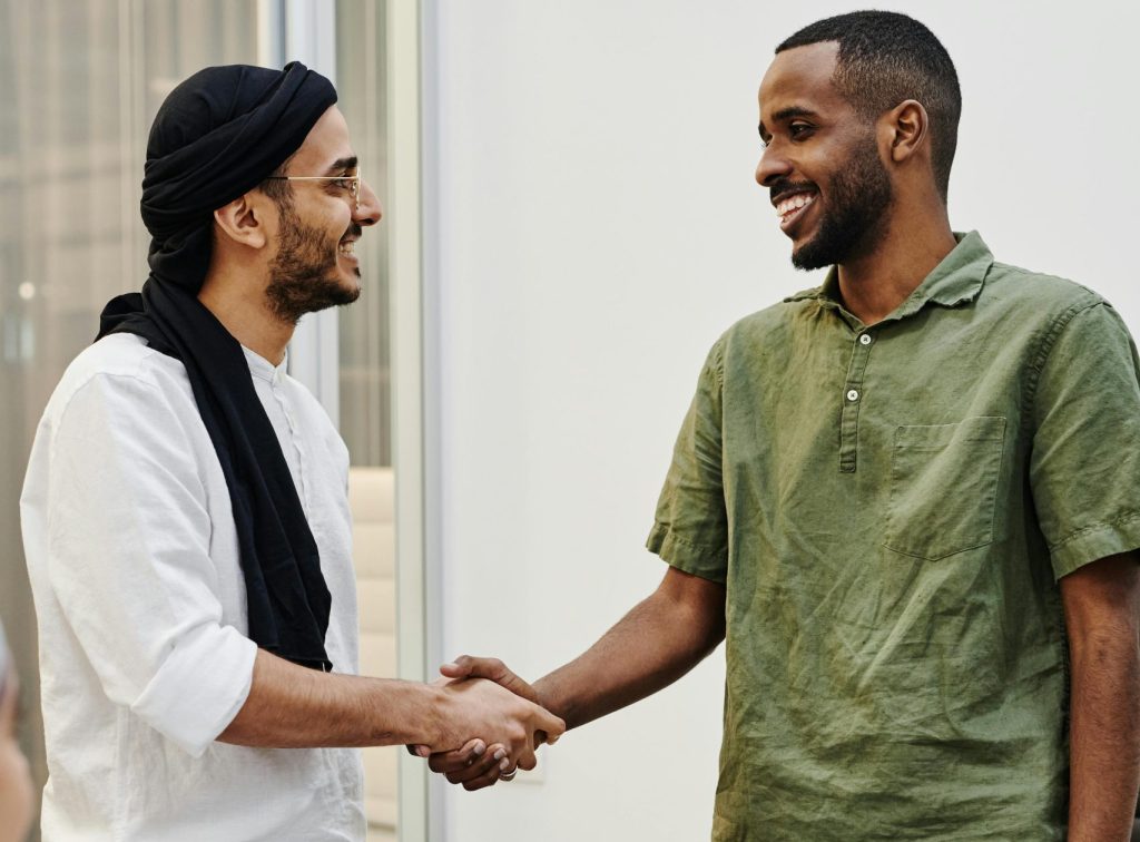 pexels-photo-8070768-8070768 Two professionals shaking hands in a friendly business meeting indoors.